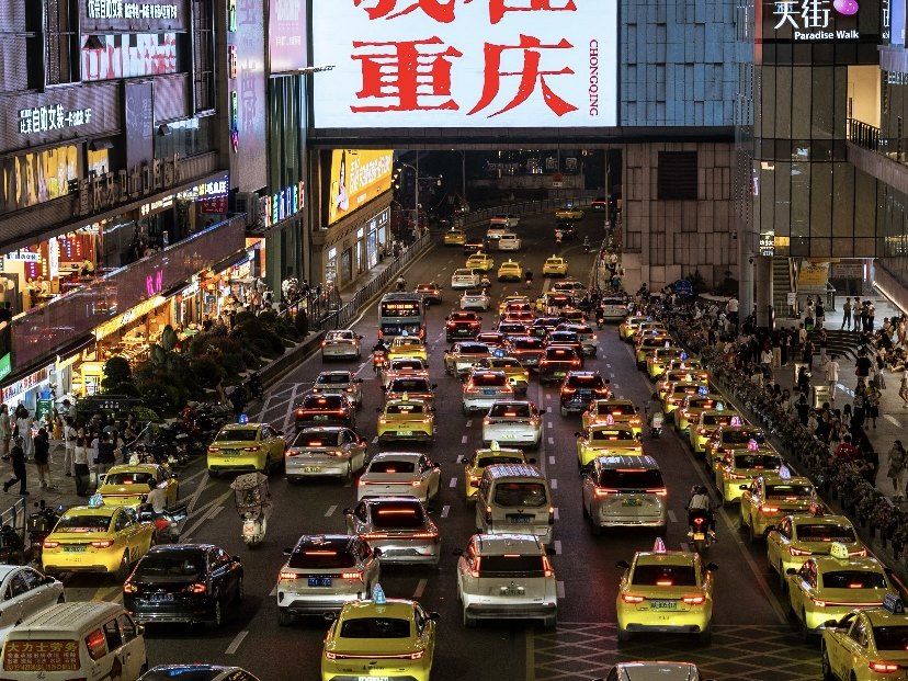 A lively illuminated Chongqing plaza at night
